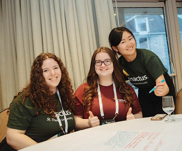 Students at a table smiling