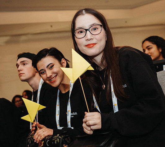 Group of students holding Enactus symbol